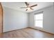 Neutral bedroom featuring wood floors, ceiling fan, bright window, and closet at 2372 Haskell Way, Watkins, CO 80137