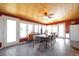 Bright dining room with tiled floor, wood ceiling and walls of windows for plenty of natural light at 2372 Haskell Way, Watkins, CO 80137