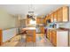 Inviting kitchen with stainless steel appliances, a center island with seating, and wood cabinetry at 2372 Haskell Way, Watkins, CO 80137