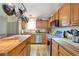 Well-equipped kitchen with stainless steel appliances, wood countertops, and a convenient pot rack at 2372 Haskell Way, Watkins, CO 80137