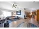 Open-concept living room with hardwood floors, modern decor, and seamless flow into the kitchen at 2372 Haskell Way, Watkins, CO 80137