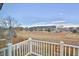 Private balcony overlooking manicured grounds and complex with mature trees in the background at 288 Dover Ct, Broomfield, CO 80020