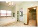 Bright bathroom features a large soaking tub, tiled floors, and a decorative chandelier at 288 Dover Ct, Broomfield, CO 80020