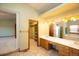 Bathroom featuring a double sink vanity, a soaking tub, and a walk-in closet at 288 Dover Ct, Broomfield, CO 80020