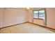 Cozy bedroom with soft pink walls and a window, creating a peaceful retreat at 288 Dover Ct, Broomfield, CO 80020