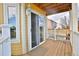 Cozy outdoor deck featuring wood floors, white railing, and a sliding glass door entrance at 288 Dover Ct, Broomfield, CO 80020