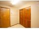 Entryway with wood doors, tile flooring, and coat hooks at 288 Dover Ct, Broomfield, CO 80020