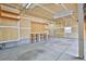 Large unfinished garage space with pegboard wall, workbench, concrete floor, and exterior door at 288 Dover Ct, Broomfield, CO 80020