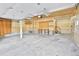 Spacious unfinished garage with concrete floor, storage, and staircase leading to a loft area at 288 Dover Ct, Broomfield, CO 80020