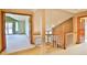 Hallway leading to living area featuring carpeted floors and a brick fireplace at 288 Dover Ct, Broomfield, CO 80020