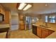 Well-lit kitchen boasting stainless steel appliances, ample counter space, and tile flooring at 288 Dover Ct, Broomfield, CO 80020