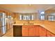 Open concept kitchen has stainless steel appliances, a breakfast bar, and views into the dining room at 288 Dover Ct, Broomfield, CO 80020