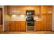 Kitchen featuring light wood cabinets, a double oven, and plenty of counter space for cooking at 288 Dover Ct, Broomfield, CO 80020