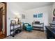 Comfortable home office with a teal accent chair, stylish shelving, and natural light for a cozy workspace at 3355 Hickok Pl, Boulder, CO 80301