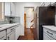 Kitchen view showing stainless steel refrigerator, brick floors, and gray cabinets at 3355 Hickok Pl, Boulder, CO 80301