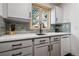 Gray kitchen cabinets and drawers with a stainless steel dishwasher at 3355 Hickok Pl, Boulder, CO 80301