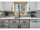 Gray kitchen cabinets with a window and a view of the outdoors at 3355 Hickok Pl, Boulder, CO 80301