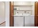 Practical laundry closet with a washer, dryer, and shelving for storage, optimizing functionality and organization at 3355 Hickok Pl, Boulder, CO 80301