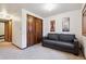 Inviting living room with a gray sofa, neutral walls, and bi-fold closet, creating a comfortable and functional space at 3355 Hickok Pl, Boulder, CO 80301