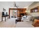 Bright living room with a cozy fireplace and access to the outdoor patio at 3355 Hickok Pl, Boulder, CO 80301