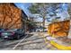 Assigned parking spot #12 with black car, multiple trees and wooden building in view at 3355 Hickok Pl, Boulder, CO 80301