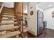 Carpeted staircase leading to living room and open kitchen with refrigerator at 3355 Hickok Pl, Boulder, CO 80301