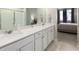 Elegant bathroom featuring double vanities and a view of the bedroom at 460 E Fremont Pl # 301, Littleton, CO 80122