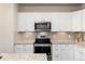 Modern kitchen with stainless steel appliances and white cabinets at 460 E Fremont Pl # 301, Littleton, CO 80122