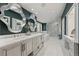 Elegant bathroom boasting double vanity, large mirrors, soaking tub, and glass enclosed shower at 344 Saint Paul St, Denver, CO 80206