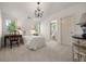 Bright bedroom features a chandelier, wood desk, white walls, and access to an ensuite bathroom at 344 Saint Paul St, Denver, CO 80206