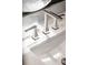 Close-up of a modern polished faucet on a sleek countertop with a white basin sink at 344 Saint Paul St, Denver, CO 80206