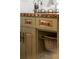 Custom kitchen cabinet with decorative hardware, open shelving, and rustic woven basket at 344 Saint Paul St, Denver, CO 80206