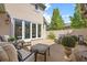 A private outdoor patio features neutral furniture, manicured landscaping, and access to the residence at 344 Saint Paul St, Denver, CO 80206