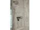 Detailed view of shower showcasing patterned tile, shower head, and built-in niche at 344 Saint Paul St, Denver, CO 80206
