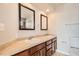 Bathroom with double sinks, tile counters, and tile flooring at 875 E 78Th Ave # 9-2, Denver, CO 80229