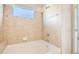 Bright bathroom featuring a tiled tub and shower combination at 875 E 78Th Ave # 9-2, Denver, CO 80229