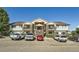 Apartment complex exterior featuring brick accents, balconies, and ample parking spaces at 875 E 78Th Ave # 9-2, Denver, CO 80229