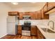 Modern kitchen featuring stainless steel appliances and rich, wood cabinetry at 875 E 78Th Ave # 9-2, Denver, CO 80229