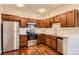 Kitchen featuring stainless steel appliances, ample counter space, and rich wood cabinets at 875 E 78Th Ave # 9-2, Denver, CO 80229