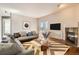 Bright living room featuring a cozy fireplace, modern furniture and a sliding glass door at 875 E 78Th Ave # 9-2, Denver, CO 80229