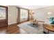 Cozy living room with hardwood floors, large windows, stylish rug, and decorative front door at 13258 E Alaska Pl, Aurora, CO 80012