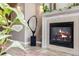 Cozy lobby with fireplace and marble mantel, accented by art and indoor greenery at 111 S Monroe St # B203, Denver, CO 80209