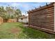 Spacious backyard with a wooden pergola, a swing set, and lush green grass at 3464 S Downing St, Englewood, CO 80113