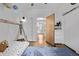 Bright bedroom with hardwood floors, playful decor, soft lighting and a unique bed frame with neutral walls at 3464 S Downing St, Englewood, CO 80113
