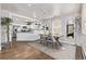 Open concept dining room featuring hardwood floors, a modern table, and a stylish rug at 3464 S Downing St, Englewood, CO 80113