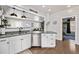 Modern kitchen island with granite counters, white cabinets, and stainless steel dishwasher at 3464 S Downing St, Englewood, CO 80113
