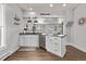 Modern kitchen island with granite counters, white cabinets, and stainless steel dishwasher at 3464 S Downing St, Englewood, CO 80113