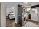 Convenient laundry room featuring stacked washer and dryer units, custom cabinets, and neutral tile floors at 3464 S Downing St, Englewood, CO 80113