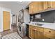 Functional laundry room featuring stacked washer and dryer units, ample cabinet space and a sink with a countertop at 3464 S Downing St, Englewood, CO 80113