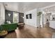 Bright living room with hardwood floors, modern decor, and a stylish green couch at 3464 S Downing St, Englewood, CO 80113